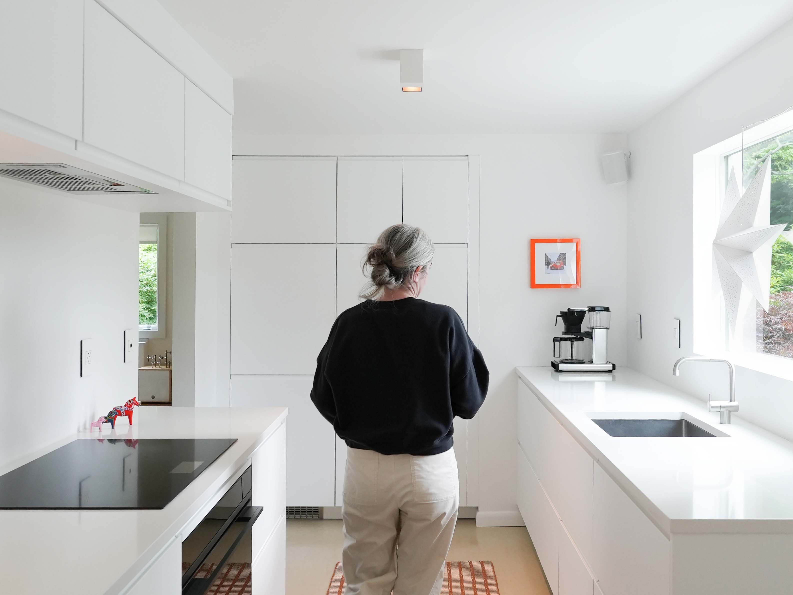 Minimalist kitchen renovation in Wayne, PA — flat-panel cabinetry and natural light by Studio Beacon