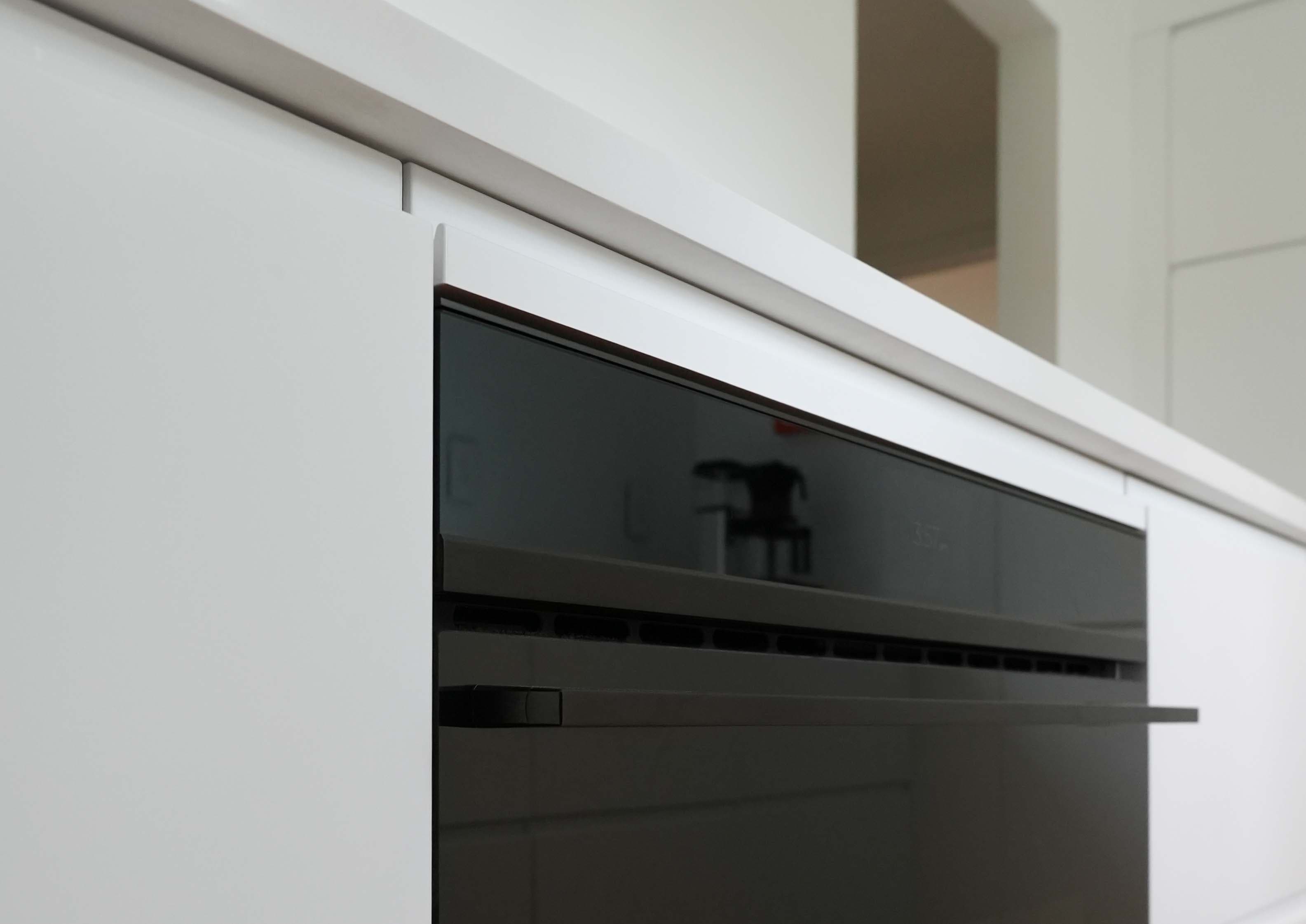Minimalist Kitchen. Minimalist kitchen with flat-panel cabinetry and a wooded view, Wayne, PA
